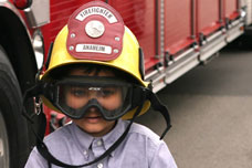 Little boy wearing fireman's helmet